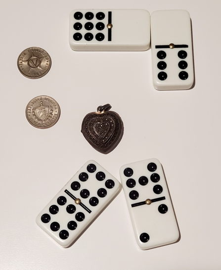 Domino dominoes and coins on a white surface Description automatically generated
